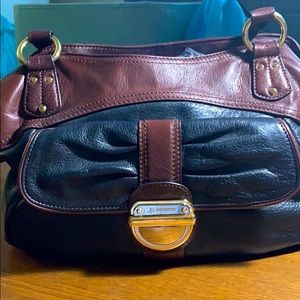 Black w/ brown trim leather hand bag.